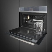 Компактный духовой шкаф с пароваркой Smeg SF4104WVCPS фото 2 в Тюмени